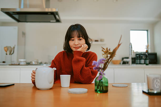 istock Young woman relaxing at home, having a tea 2227288685