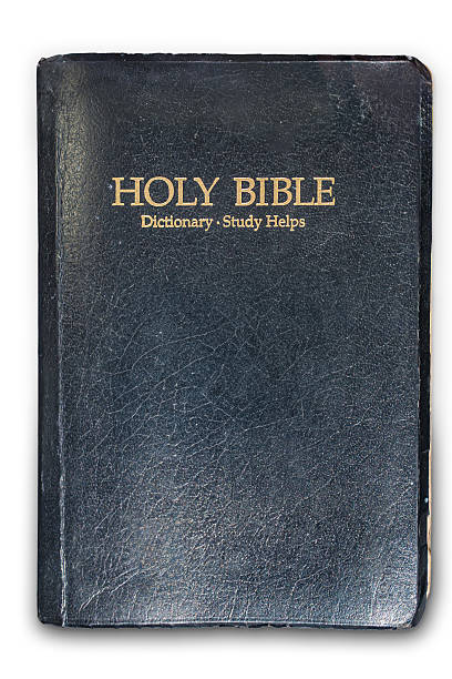 istock A black leather-bound Holy Bible with gilded edges is shown open on a surface, revealing white interior pages and black printed text The title HOLY BIBLE is embossed or printed above the spine 2227288693