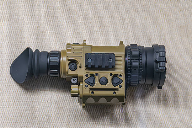 istock Olive green thermal imager with tactical design, mounted on a fabric surface, multiple buttons and switches, natural lighting, diffuse light source 2227290861