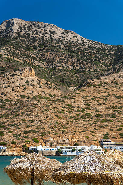 Ancient ruins, White washed buildings and blue waters of the Cyclades islands chain Greece
