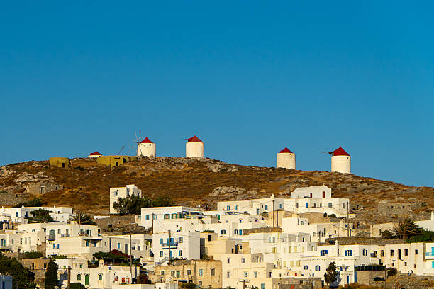 Ancient ruins, White washed buildings and blue waters of the Cyclades islands chain Greece