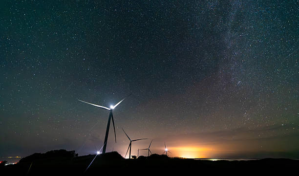 istock Wind farm turbines at night under a starry sky 2227293114