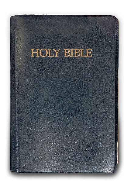 istock Aged, leather-bound King James Version Bible with gold embossed title on spine is open to scriptures 2227293632