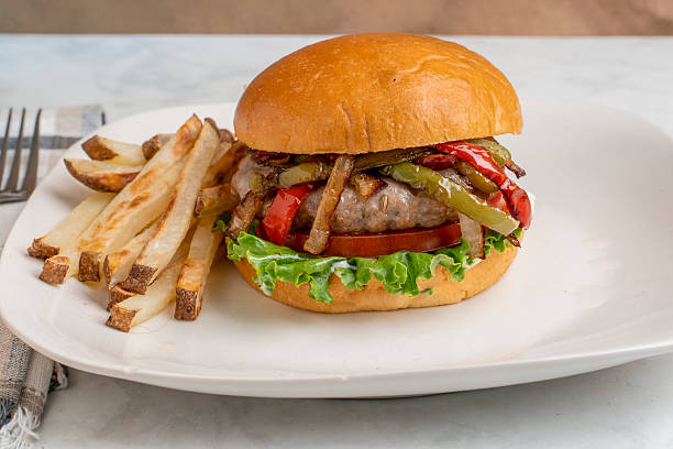 istock sausage burger  top with peppers and onions 2227294179