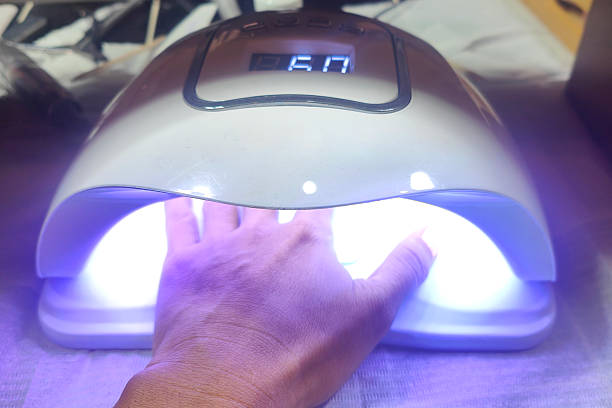istock UV Nail Lamp Drying Gel Polish on Hand 2227294855