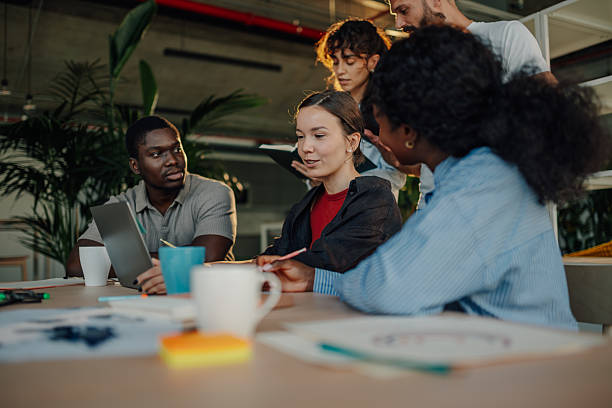istock Diverse business team collaborating on project using laptop in modern office 2227295458