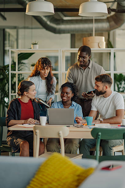 istock Diverse business team collaborating on project using laptop in modern office 2227295466