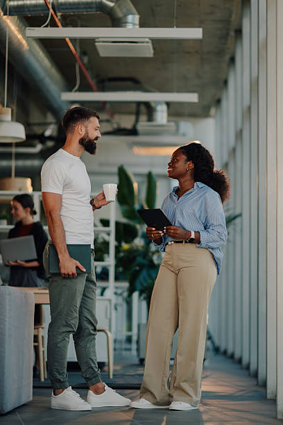 istock Business colleagues engaging in conversation at modern office 2227295578