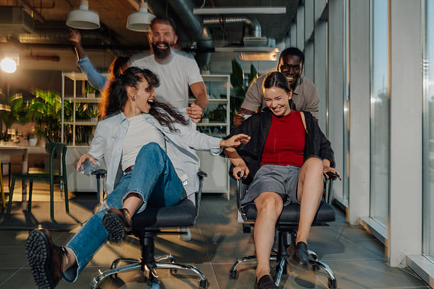 istock Cheerful business colleagues having fun on office chairs 2227295590