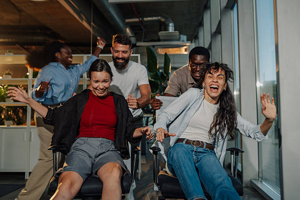 istock Coworkers having fun on office chairs during break time 2227295592