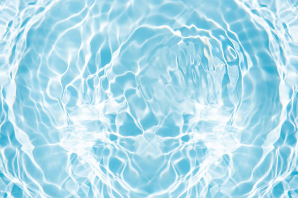 Clear and vibrant surface of blue water with visible light sparkles and soft movement. Perfect as a nature background or abstract texture for travel and design use.