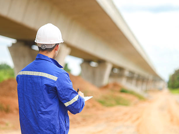 istock Engineer male road construction working with blueprint. finished asphalt road worker inspector check quality. 2227297622