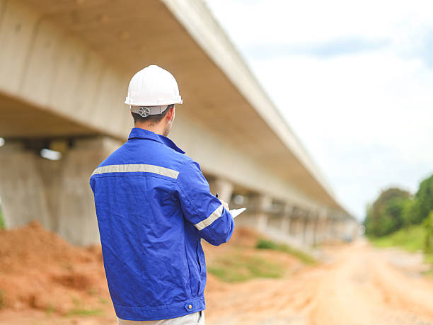 istock Engineer male road construction working with blueprint. finished asphalt road worker inspector check quality. 2227299217