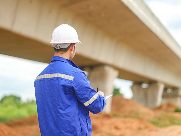 istock Engineer male road construction working with blueprint. finished asphalt road worker inspector check quality. 2227299218