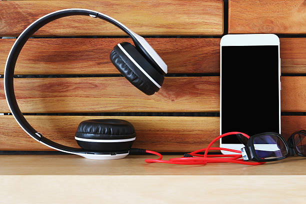 Headphones  and smartphone on wood floor background ,Concept listen to music