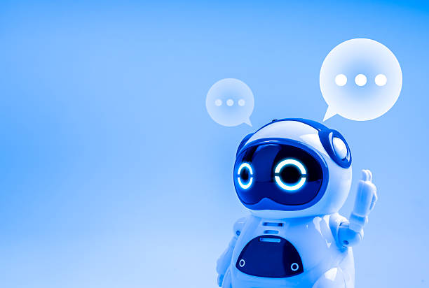 istock White smart cute 3d robot raising hand with speech bubbles isolated on blue background with copyspace. AI smart bot, chatbot customer service, artificial intelligence assistant technology concept. 2227308250