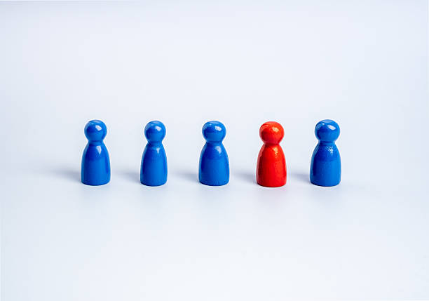 istock Stand out from the crowd, leadership, unique, influencer, talent people, difference concept. The red one standing different in the group of blue wooden figures, people symbols, on white background. 2227308275