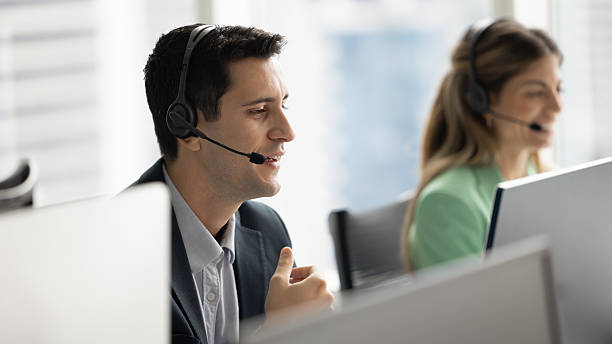 istock Positive Hispanic telephone support employee man speaking to customer 2227309634