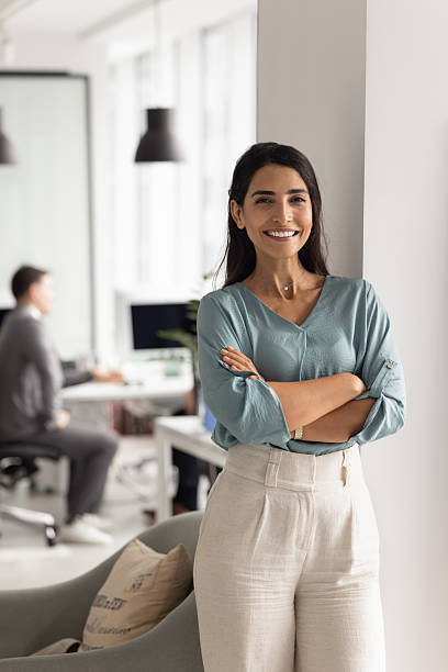 istock Confident young Hispanic business lady standing in office workspace 2227310230