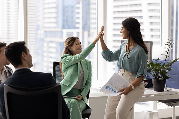 istock Cheerful Hispanic female business colleagues making high five 2227310485