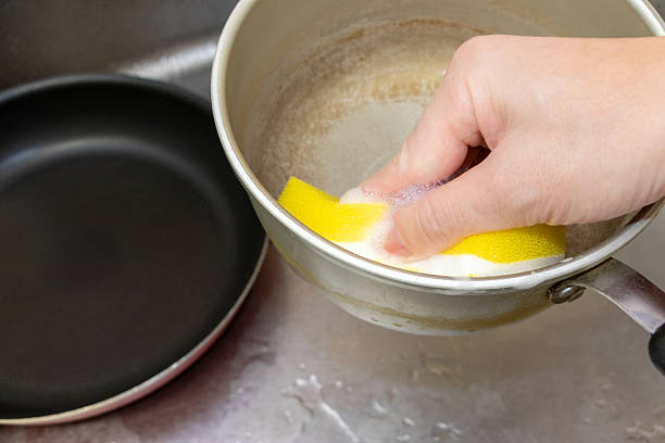 istock Wash the pot with a kitchen sponge 2227315272