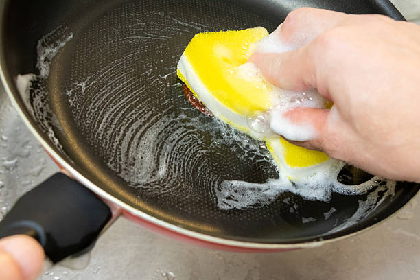 istock Wash the pan with a kitchen sponge 2227315274