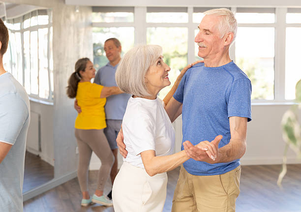 istock Senior woman and man dancing slow ballroom dance during group class 2227317058