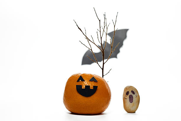Halloween Decorations Using Fruits and Minimalistic Art Showcased in a Studio Setting
