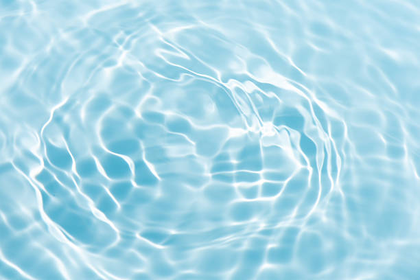 istock Blue water with ripples on the surface. Defocus blurred transparent blue colored clear calm water surface texture with splashes and bubbles. Water waves with shining pattern texture background. 2227317858