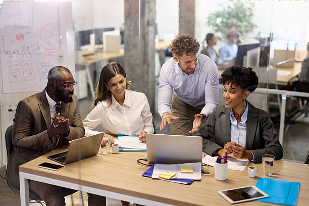 istock Happy diverse colleagues working on laptops in a modern office. 2227321098