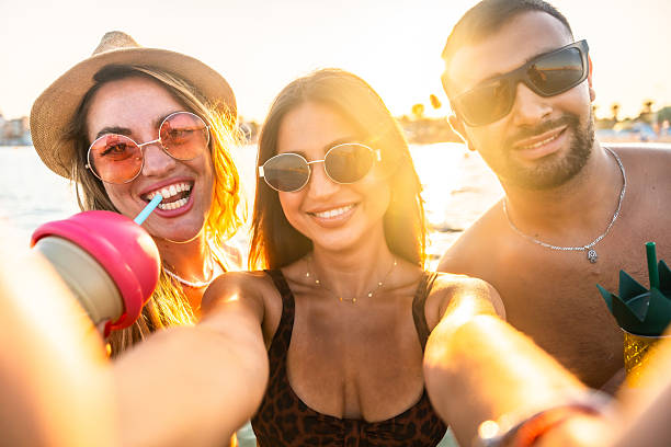 istock Happy friends taking a selfie at the beach during sunset 2227322891