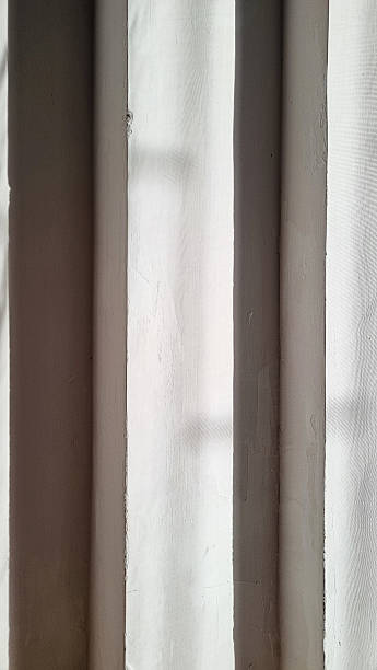 istock Light and Shadow Contrast on a Textured Wall with Harsh Lines. 2227325133