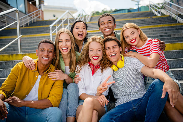 istock Buddies posing together outdoors on stairs, enjoying sunny day while bonding and celebrating life 2227325666