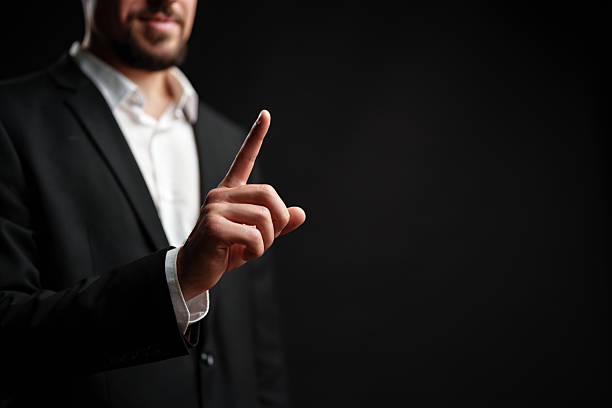 istock Businessman gestures with one finger indicating importance in a dark setting during a professional discussion 2227327126
