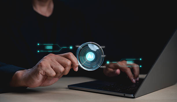 istock A person interacting with a laptop, holding a magnifying glass highlighting AI technology with digital futuristic interface elements. 2227329140
