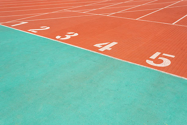 Red running track with numbered starting lines outdoor for exercising for health