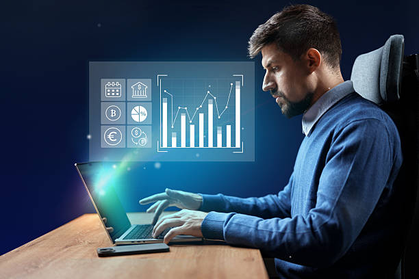 istock Young professional analyzes data and trends while working on a laptop in a modern office setting in the evening 2227331961