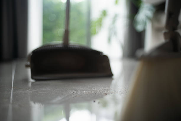 Cleaning house with broom.