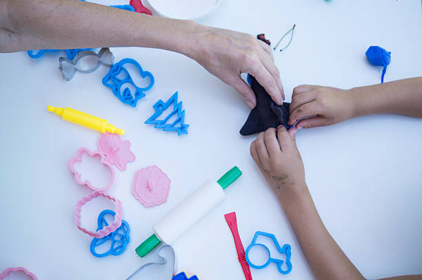 istock Teacher helping a child in crafts class 2227334578