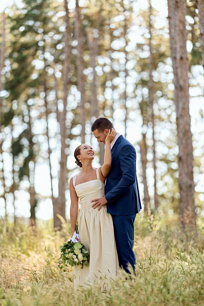 istock Bride and Groom Embracing in a Serene Forest Setting During Daytime 2227336999