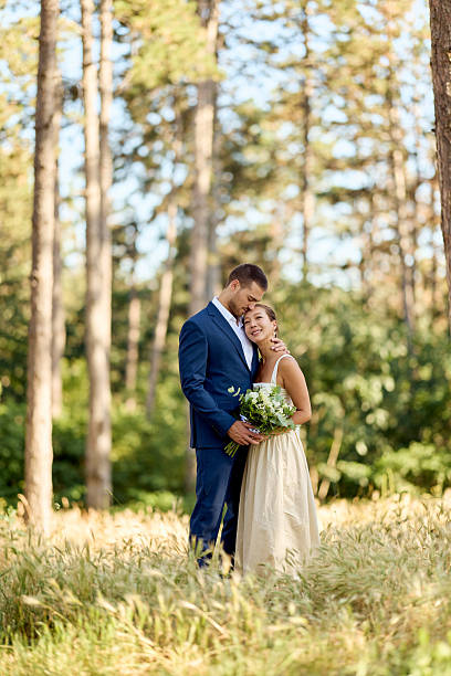 istock Couple Embracing Outdoors During Wedding Celebration in Scenic Woodland Setting 2227337014