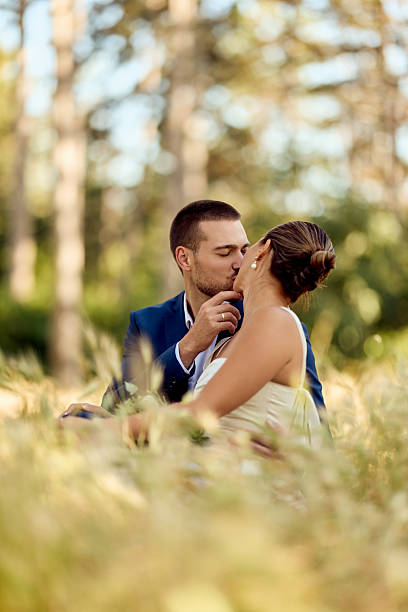 istock Romantic Couple Kissing Outdoors in a Scenic Natural Field Setting 2227337022