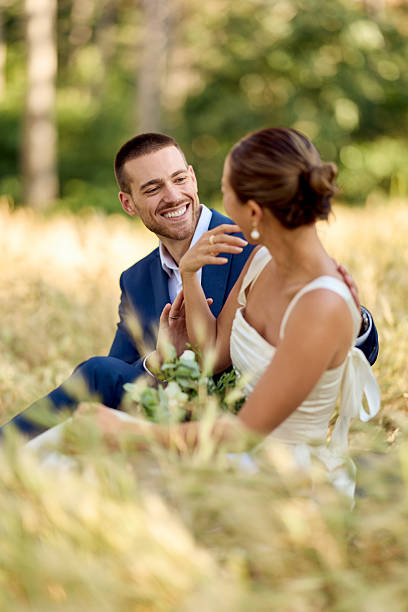 istock Couple Smiling Outdoors in a Romantic Wedding Setting Surrounded by Nature 2227337028