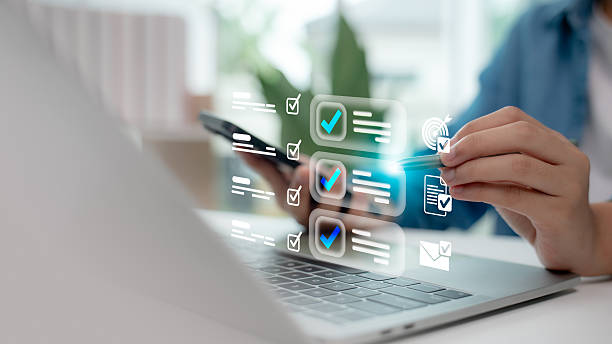 istock Hand using digital checklist interface on laptop and smartphone. Concept of productivity, task management, goal tracking, online planning system, and efficient workflow organization. 2227337551