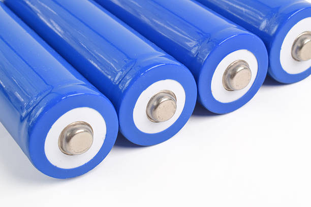 istock Alkaline batteries and a blue metal AA-size batteries 2227338008