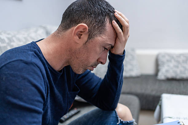 istock Depressed man suffering from anxiety and stress at home 2227338019