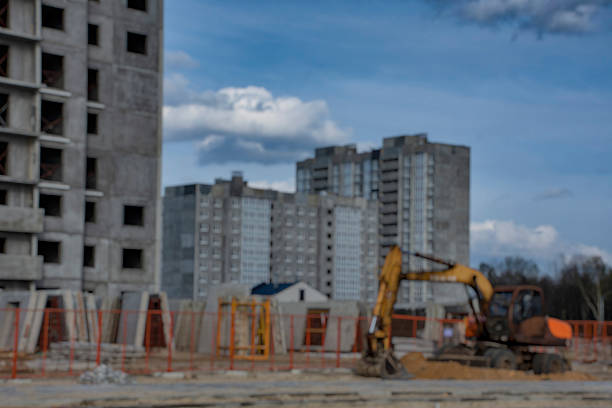 Blurred image captures the essence of a construction site, featuring multiple buildings under a vast sky