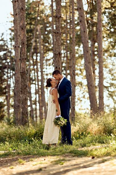 istock Bride and Groom Embracing in a Tranquil Pine Forest Setting 2227339872