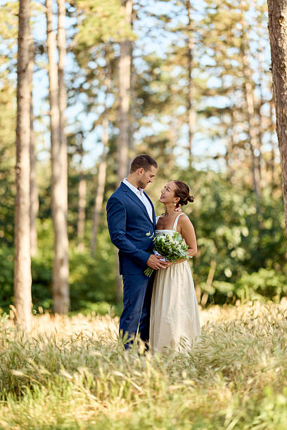 istock Bride and Groom Embracing in a Serene Outdoor Forest Setting 2227339873
