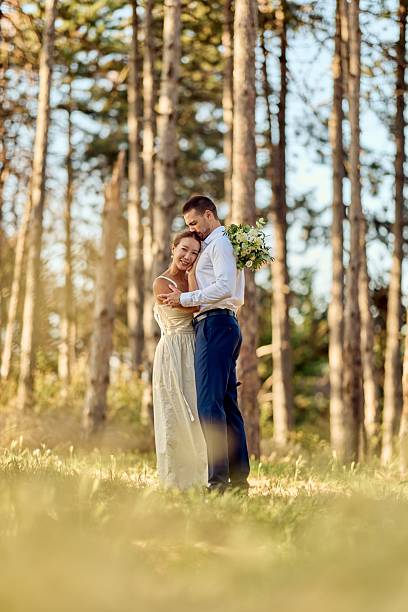 istock Romantic Couple Embracing Outdoors During Sunset Amidst Tall Trees 2227339884